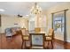 Elegant dining room featuring a chandelier, hardwood floors, and open access to the living area at 17536 Se 119Th Cir, Summerfield, FL 34491