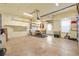 Spacious garage with ample storage shelving and a workbench area at 17536 Se 119Th Cir, Summerfield, FL 34491