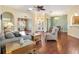 Bright living room showcasing hardwood floors, arched doorways, and a comfortable seating arrangement at 17536 Se 119Th Cir, Summerfield, FL 34491