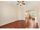 Spacious living room with hardwood floors, ceiling fan, and an open view to the sunroom at 17536 Se 119Th Cir, Summerfield, FL 34491