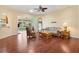 Spacious living room boasts hardwood floors, a ceiling fan, and an open layout at 17536 Se 119Th Cir, Summerfield, FL 34491