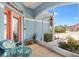 Cozy screened-in porch features comfortable seating and a view of the landscaped front yard at 17536 Se 119Th Cir, Summerfield, FL 34491