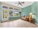 Cozy sunroom featuring tile floors, a ceiling fan, and large windows overlooking the backyard at 17536 Se 119Th Cir, Summerfield, FL 34491