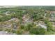 Residential area featuring well-maintained homes with green roofs, interspersed with dense trees and lush foliage at 1866 Ne 39Th Ct, Ocala, FL 34470
