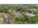 Residential neighborhood featuring homes with green roofs, surrounded by dense trees and lush lawns from an aerial perspective at 1866 Ne 39Th Ct, Ocala, FL 34470