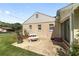 Back of house featuring a patio with a table, landscaping, and a well-manicured lawn at 1866 Ne 39Th Ct, Ocala, FL 34470