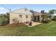Exterior shot of the home showing a backyard patio, brick chimney, and lawn at 1866 Ne 39Th Ct, Ocala, FL 34470