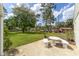 Home backyard featuring a table and chairs, grass, and trees at 1866 Ne 39Th Ct, Ocala, FL 34470