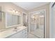 Well-lit bathroom with vanity, sink, mirror, and mirrored closet doors at 1866 Ne 39Th Ct, Ocala, FL 34470