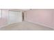 Bedroom with light pink walls, carpet, closet and doorway at 1866 Ne 39Th Ct, Ocala, FL 34470