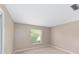 Small, carpeted, neutral bedroom with natural light at 1866 Ne 39Th Ct, Ocala, FL 34470