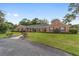 Exterior shot of brick ranch-style house with green shutters and a well-manicured front lawn at 1866 Ne 39Th Ct, Ocala, FL 34470