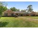 Charming brick home features green shutters, a well-manicured lawn, and inviting curb appeal at 1866 Ne 39Th Ct, Ocala, FL 34470