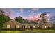 Charming brick home features green shutters, a well-manicured lawn, and inviting curb appeal at 1866 Ne 39Th Ct, Ocala, FL 34470