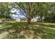 This property features a sprawling front yard with mature trees, offering privacy and curb appeal at 1866 Ne 39Th Ct, Ocala, FL 34470