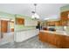 Bright kitchen with wooden cabinetry, stainless steel appliances, and a gray tile floor at 1866 Ne 39Th Ct, Ocala, FL 34470