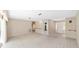 Spacious living room with neutral carpet, bright windows, neutral paint, and access to other rooms at 1866 Ne 39Th Ct, Ocala, FL 34470