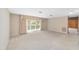 Spacious living room with neutral walls, plush carpet, and a large window for natural light at 1866 Ne 39Th Ct, Ocala, FL 34470