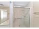Bathroom shower with glass doors, grab bars, and tile surround at 1866 Ne 39Th Ct, Ocala, FL 34470