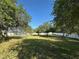 Large backyard enclosed by a white fence with a screened pool visible in the distance at 1961 Sw 170Th Loop, Ocala, FL 34473