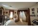 Bedroom with dark wood dresser, a chaise lounge, decorative drapery and carpeted floor at 1961 Sw 170Th Loop, Ocala, FL 34473