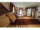 Comfortable main bedroom featuring a decorative wood bed frame and large windows with decorative drapes at 1961 Sw 170Th Loop, Ocala, FL 34473