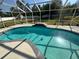 Inviting in-ground pool within a screened enclosure, providing a private and relaxing oasis at 1961 Sw 170Th Loop, Ocala, FL 34473