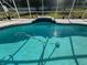 A view of a sparkling in-ground pool within a screened enclosure at 1961 Sw 170Th Loop, Ocala, FL 34473