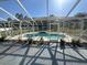 View of the pool from the patio with a seating area and an enclosed screen around the outdoor space at 1961 Sw 170Th Loop, Ocala, FL 34473
