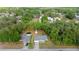 Bird's eye view of a property featuring a home, storage shed, and pool amidst lush greenery at 2199 Se 175Th Ter, Silver Springs, FL 34488