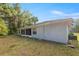 View of a large backyard with screen porch of a blue home, perfect for outdoor entertaining at 2199 Se 175Th Ter, Silver Springs, FL 34488