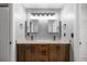 Bathroom featuring double vanity with granite countertop, dark wood cabinets, and modern lighting at 2199 Se 175Th Ter, Silver Springs, FL 34488