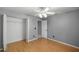 A bedroom has a ceiling fan, closet, and hardwood floors at 2199 Se 175Th Ter, Silver Springs, FL 34488