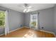 A bedroom has a window with curtains, a ceiling fan, and hardwood floors at 2199 Se 175Th Ter, Silver Springs, FL 34488