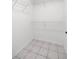 A walk-in closet features tiled floor and wire shelving at 2199 Se 175Th Ter, Silver Springs, FL 34488