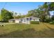 Charming blue home with a well-manicured lawn and driveway at 2199 Se 175Th Ter, Silver Springs, FL 34488