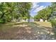 Expansive backyard featuring lush greenery, mature trees, and various outbuildings, perfect for outdoor activities at 2300 Ne 49Th St, Ocala, FL 34479