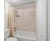 The bathroom features tiled walls, a shower-tub combination, and an updated shower head at 2300 Ne 49Th St, Ocala, FL 34479