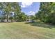 Charming single story house with a large front lawn, surrounded by mature trees at 2300 Ne 49Th St, Ocala, FL 34479
