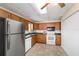 An inviting kitchen featuring a full suite of appliances and tiled flooring at 2300 Ne 49Th St, Ocala, FL 34479