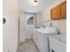 Functional laundry room with washer, dryer, utility sink, and convenient storage at 2300 Ne 49Th St, Ocala, FL 34479