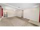 Open-concept living room features neutral carpet, white walls, and open view into the kitchen at 2300 Ne 49Th St, Ocala, FL 34479