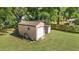 A storage shed and additional small building in a grassy, fenced backyard at 2300 Ne 49Th St, Ocala, FL 34479