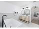 Bathroom featuring a modern tub, double vanity, and ample natural light from the large window at 3011 Se 46Th Ave, Ocala, FL 34480