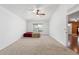 Bedroom with neutral carpet, ceiling fan, and a double window with a neighborhood view at 3011 Se 46Th Ave, Ocala, FL 34480