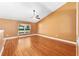Large bedroom with a ceiling fan and beautiful hardwood floors illuminated by natural light at 3011 Se 46Th Ave, Ocala, FL 34480