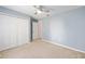 The spacious bedroom has a ceiling fan, carpet, and a closet at 3011 Se 46Th Ave, Ocala, FL 34480