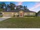 Beautiful single-story home boasting a well-kept lawn, landscaped yard, and neutral exterior at 3011 Se 46Th Ave, Ocala, FL 34480