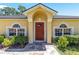 Inviting front entrance with arched windows and a beautifully landscaped garden at 3011 Se 46Th Ave, Ocala, FL 34480