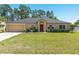 Charming one-story home with a well-manicured lawn and mature trees at 3011 Se 46Th Ave, Ocala, FL 34480